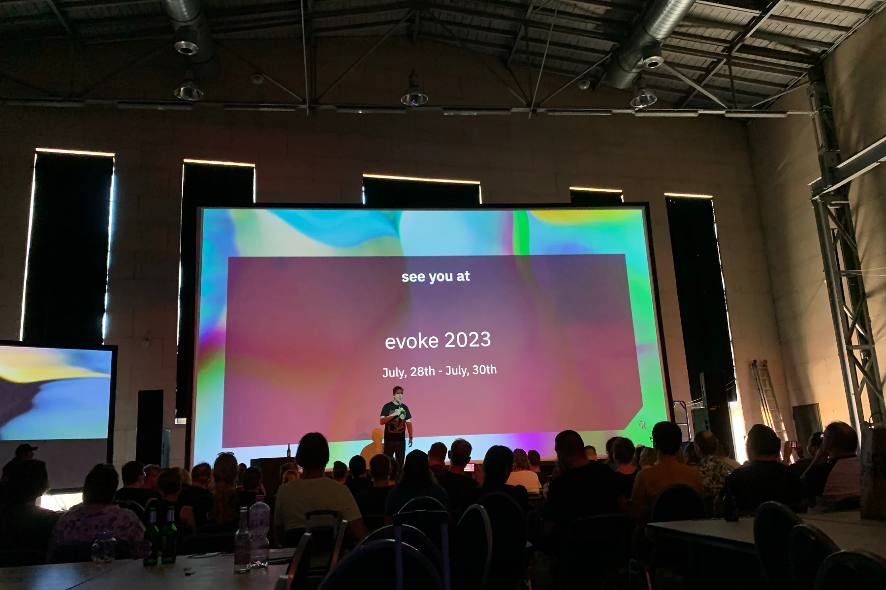 The main stage with the large screen showing the date of the next Evoke demoparty on July 28 to 30, 2023