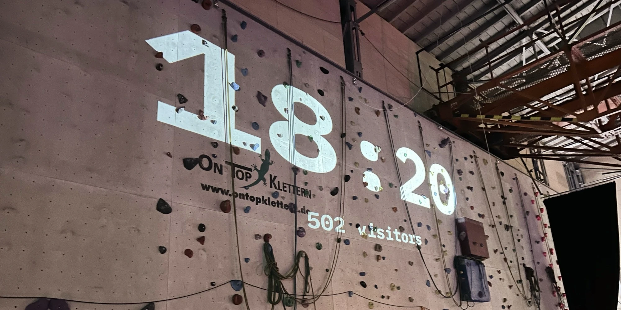 The number of visitors is projected onto the wall