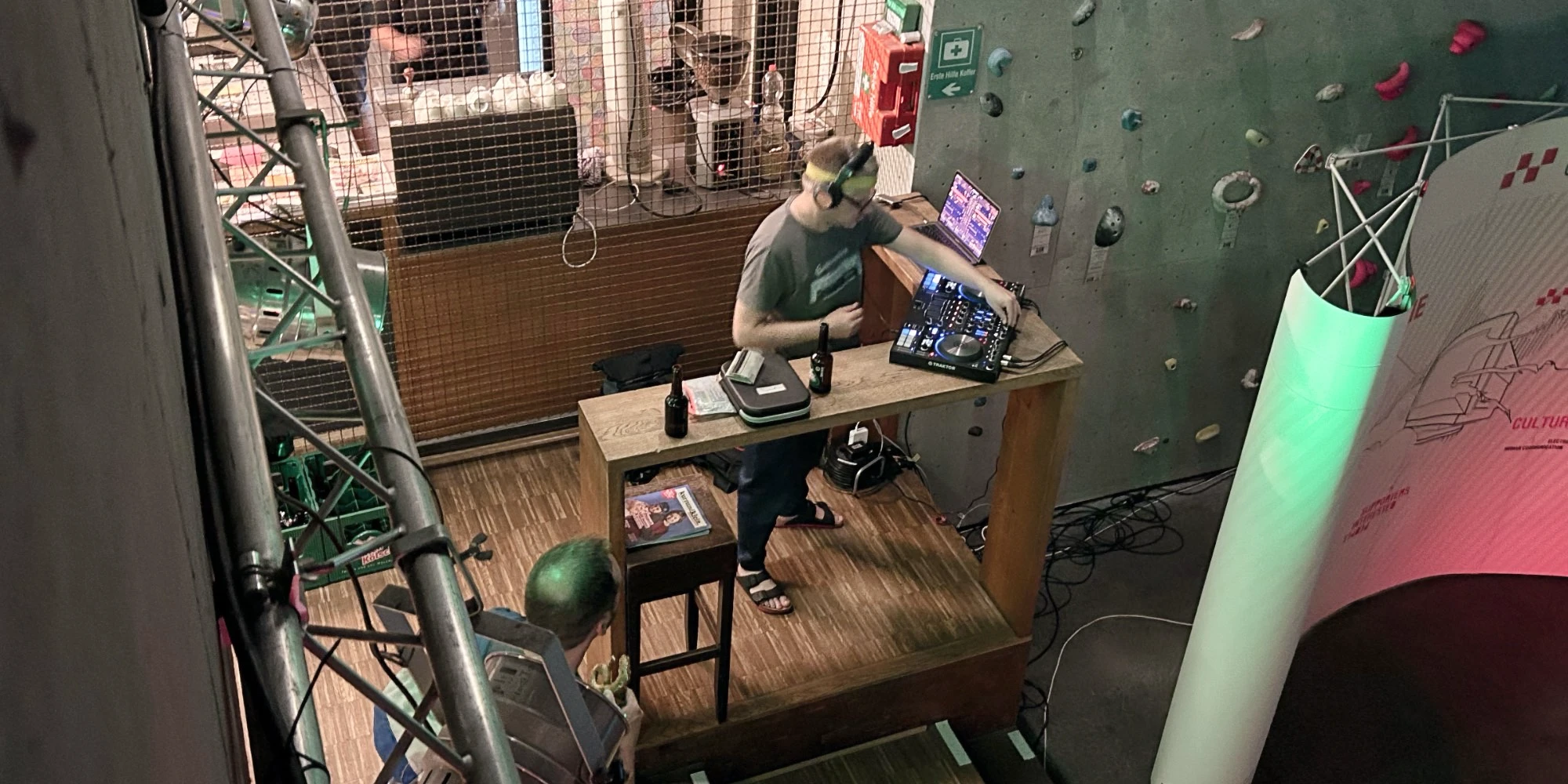 The DJ in his booth near the bar area