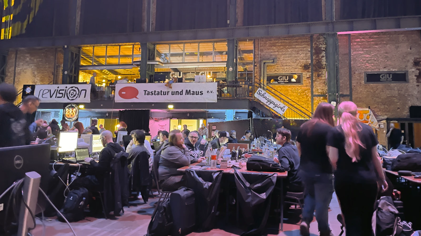 A close view of participant workspaces with computers and retro equipment.